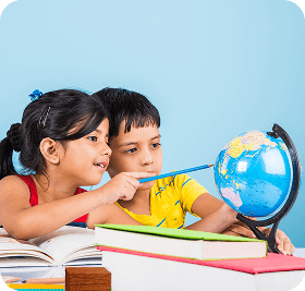 Two kids studying a globe together